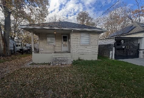 A house with a porch and a garage, located near Harman Apartments Springville.