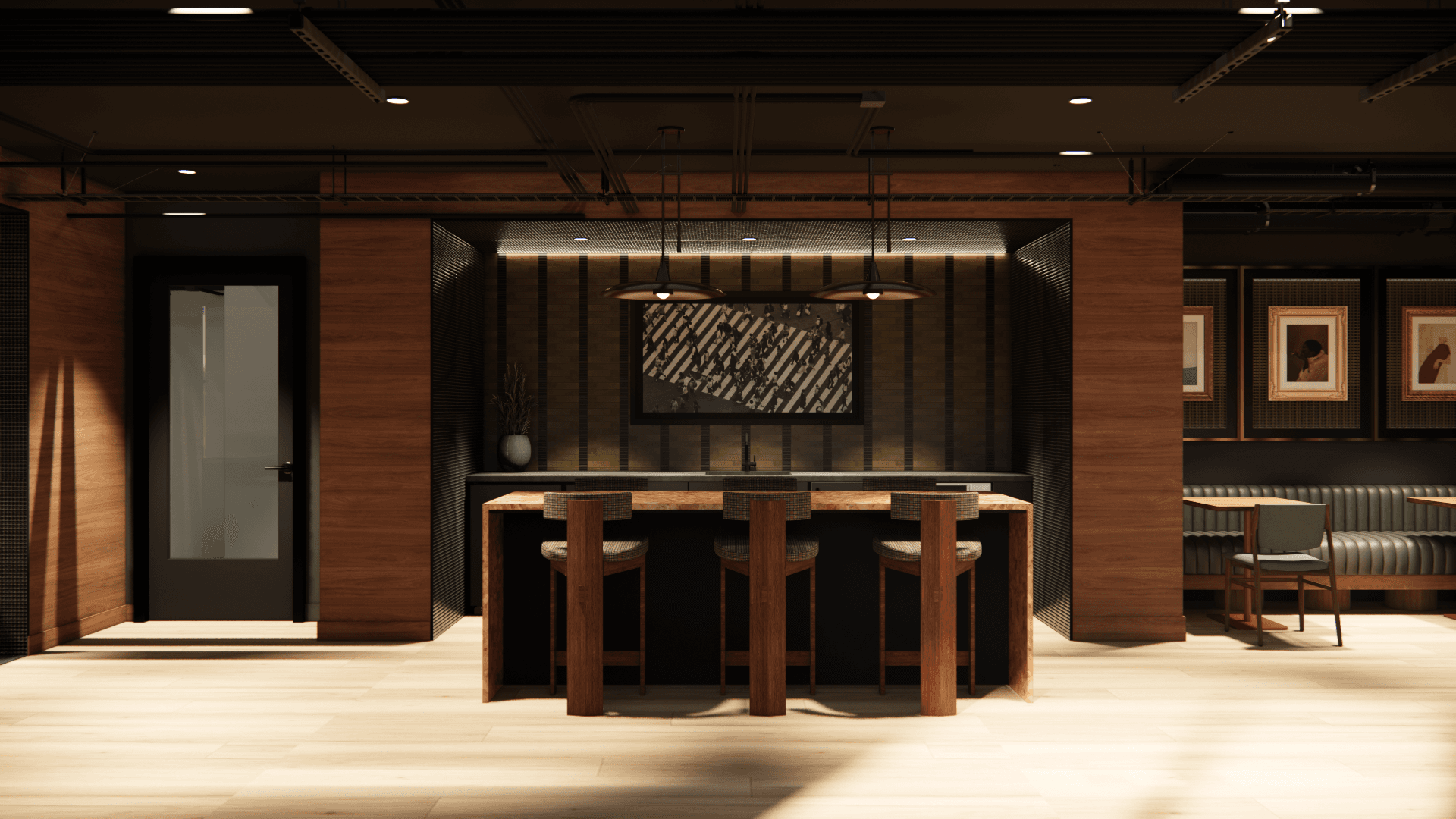 A modern interior at Yugo Salt Lake City features a wooden island with three barstools, pendant lights above, a framed abstract art piece on the back wall, and additional seating with framed art along the right side.