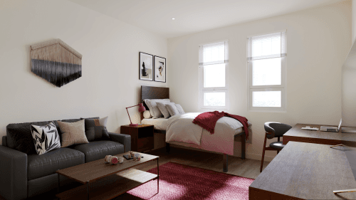 A bedroom in Ivory University House, Salt Lake City, featuring a comfortable bed and a cozy couch.