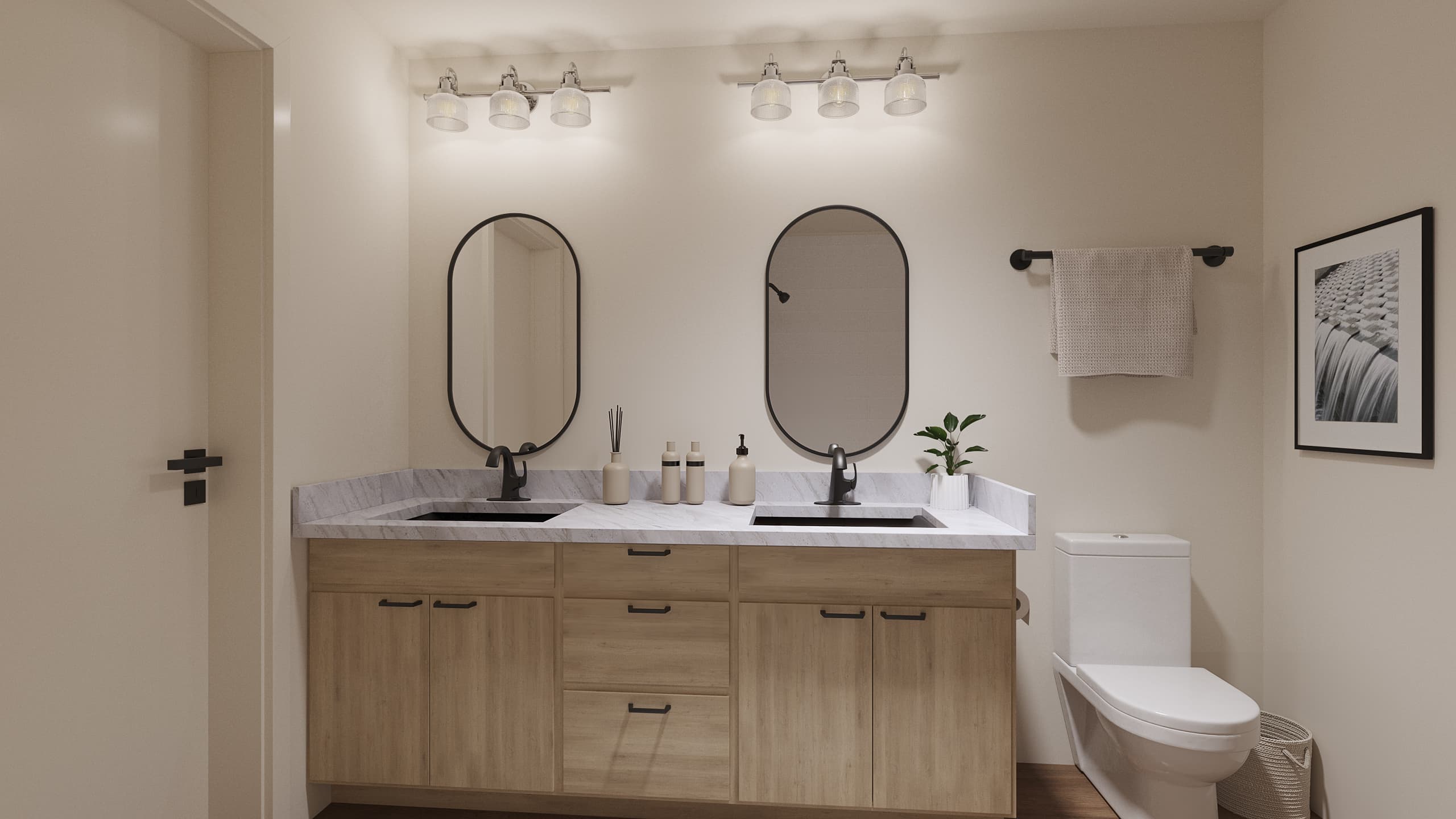 A modern bathroom with a double sink vanity, two arched mirrors, black fixtures, a white toilet, a towel rack with a beige towel, and a framed black-and-white photo on the wall. The room has neutral tones.