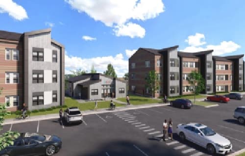 A parking lot in front of modern three-story Pullman apartments with cars parked and people walking on a sunny day under blue sky and white clouds, perfect for student housing.