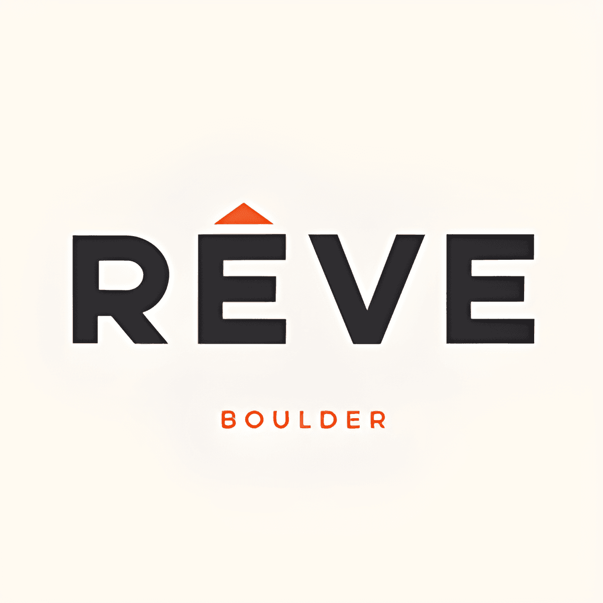 The image displays the word RÊVE in bold black letters with a small orange triangle over the E. Below, “BOULDER” appears in smaller orange letters, highlighting Reve Boulder Apartments. The background is off-white.