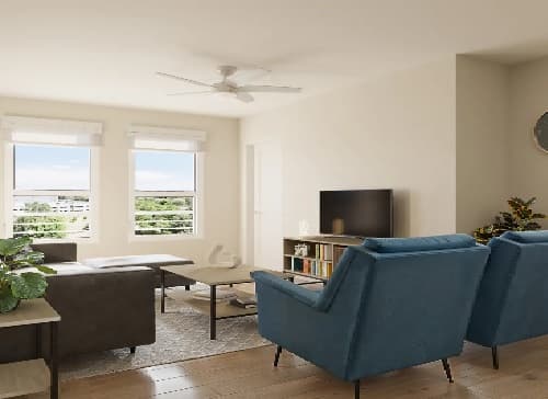Modern living room at The Mark Fort Collins with large windows, blue armchairs, a dark sofa, coffee table, TV on a stand with books, indoor plants, and wood flooring. The space is bright with natural light.