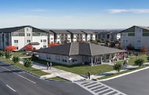 Union at Pacific Highway is a modern apartment complex with three-story buildings surrounding a central clubhouse on a landscaped corner lot. Sidewalks, crosswalks, and small groups of people are visible under a clear blue sky.