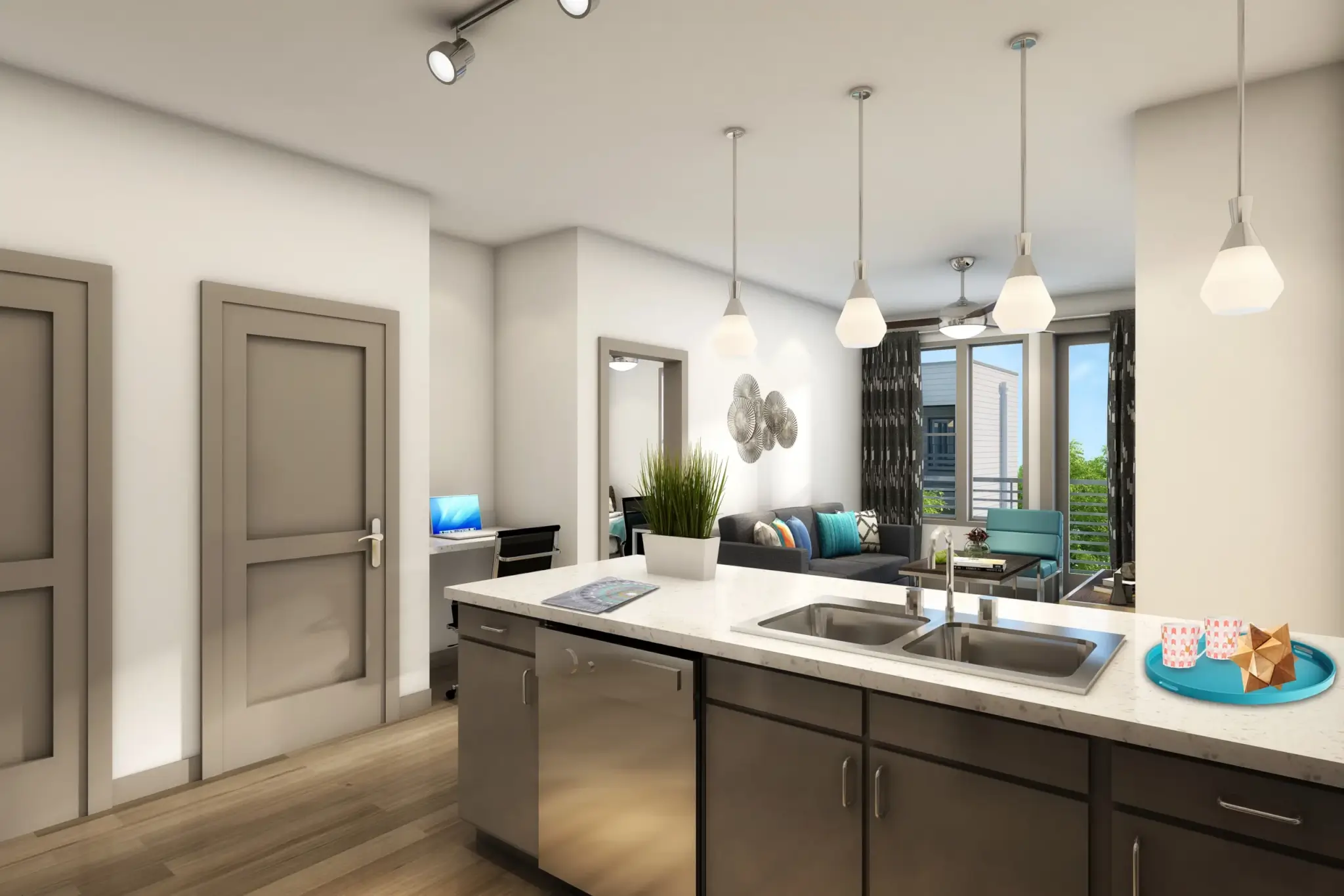 Modern apartment kitchen at Campus Walk Chico featuring a white countertop island, stainless steel sink, pendant lights, and a view into a bright living area with sofa, wall art, large windows, and balcony.