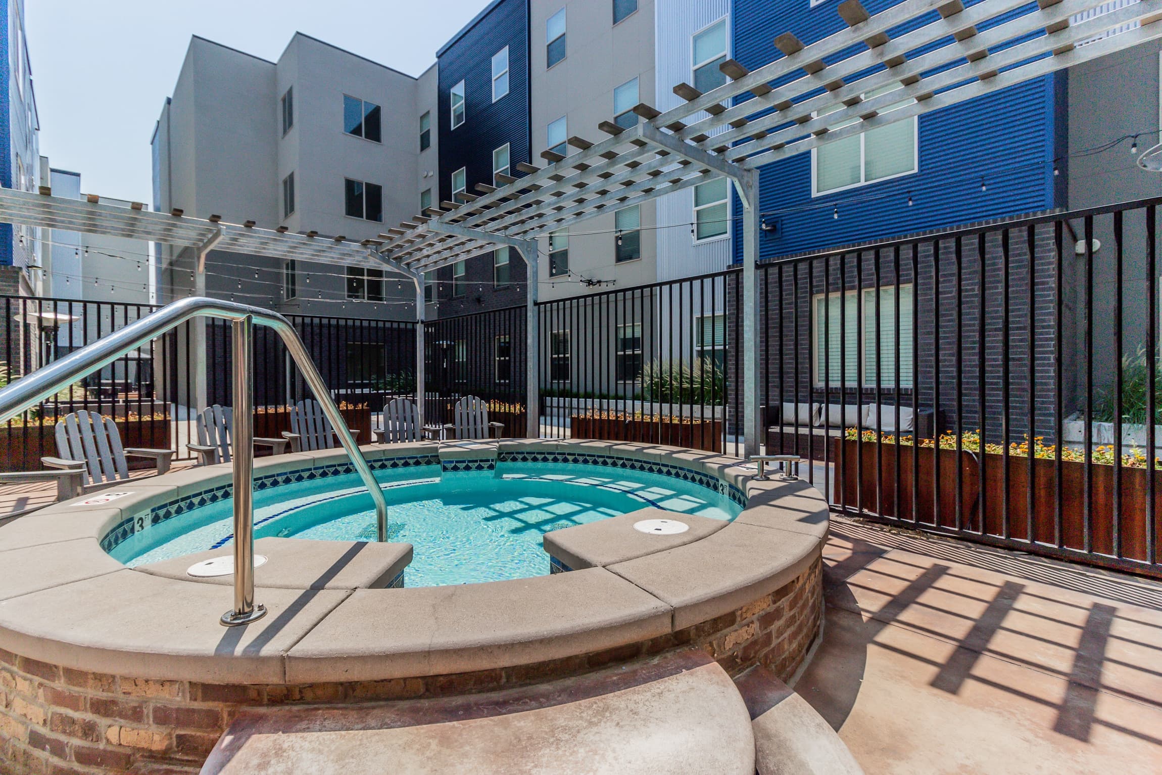The photo shows the exterior of CollegePlace Provo, a modern multi-story building featuring a sign above the entrance. The facade combines sleek dark brick with light-colored concrete for a contemporary look.